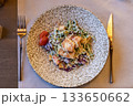 Fresh caesar salad with grilled chicken and cherry tomatoes in rustic ceramic bowl 133650662
