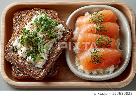 Gourmet high-protein breakfast. Smoked salmon and cream cheese on whole-grain toast. Keto friendly breakfast. Menu design. Top view. 133650822