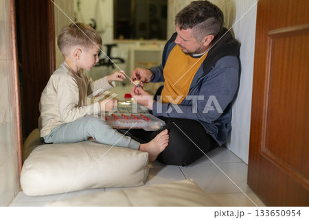 Father and son bonding sharing creative hobby moment 133650954