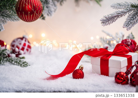 Christmas Gift and Ornaments on Snow with Tree Branches 133651338