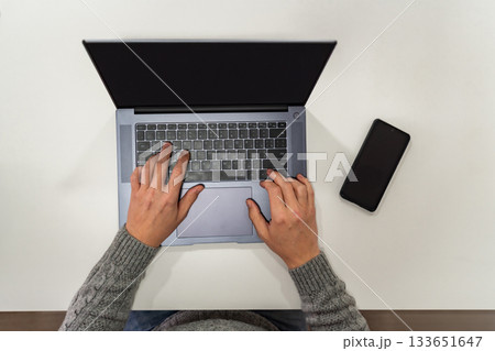 Top view, male hands using laptop Top view, male hands using laptop 133651647