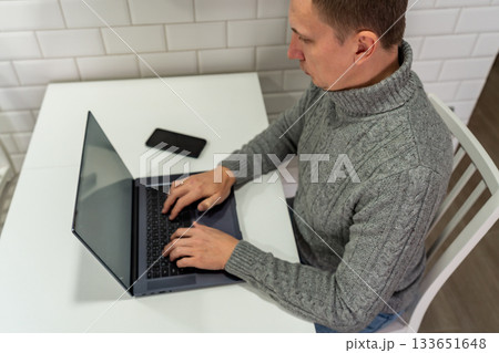 Middle aged man looking at laptop Middle aged man looking at laptop 133651648