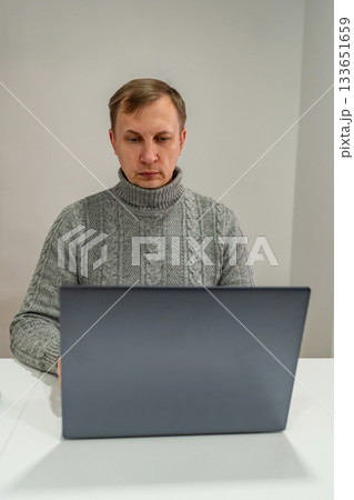 Middle aged man looking at laptop 133651659