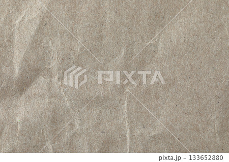 Crumpled kraft paper texture, macro close-up. Ideal as a natural background or design element for eco and craft-themed projects Crumpled kraft paper texture, macro close-up. Ideal as a natural background or design element for eco and craft-themed projects 133652880