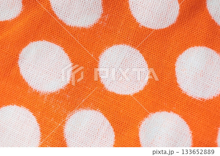 Macro texture of retro orange fabric with white polka dots. Stylish background for vintage, textile, design, fashion, home decor, and creative projects Macro texture of retro orange fabric with white polka dots. Stylish background for vintage, textile, design, fashion, home decor, and creative projects 133652889