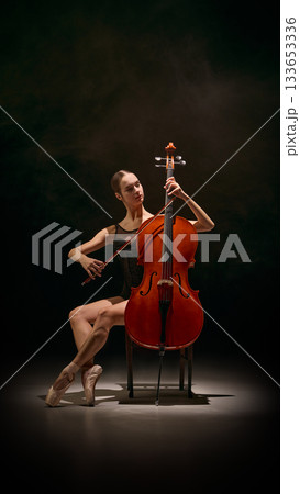 Cellist ballerina combining pointe balance with musical performance 133653336
