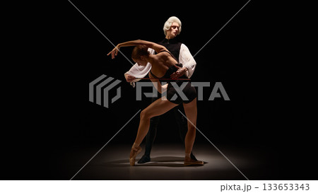 Classical mentor directing deep curved ballet pose with instrument-like control Classical mentor directing deep curved ballet pose with instrument-like control 133653343