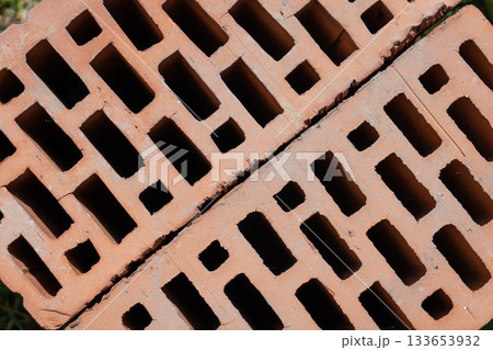 Clay red brick close-uo macro texture. Construction brick isolate on white 133653932