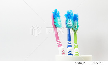 Old Worn Toothbrushes in Cup for Dental Hygiene Concepts Old Worn Toothbrushes in Cup for Dental Hygiene Concepts 133654459