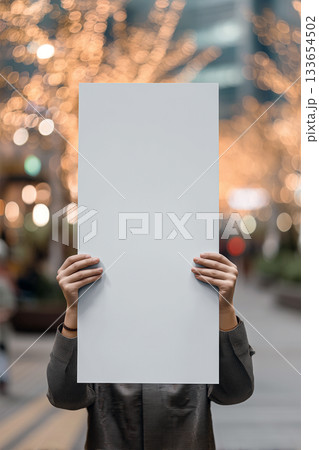 Realistic banner mockup in hands with soft bokeh and a vivid outdoor atmosphere Realistic banner mockup in hands with soft bokeh and a vivid outdoor atmosphere 133654502