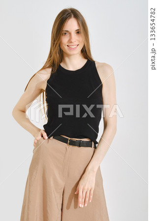 Trendy female outfit blends style with convenience for everyday wear in a modern setting Trendy female outfit blends style with convenience for everyday wear in a modern setting 133654782