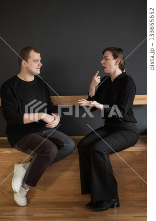 A man and a woman are talking in Russian sign language. A man and a woman are talking in Russian sign language. 133655652