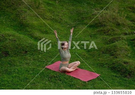 Caucasian woman doing yoga outdoors.  133655810
