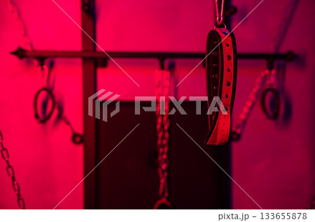 BDSM installation. Wall with chains and handcuffs. 133655878