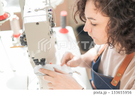 Woman tanner at work in the workshop. Woman tanner at work in the workshop. 133655956