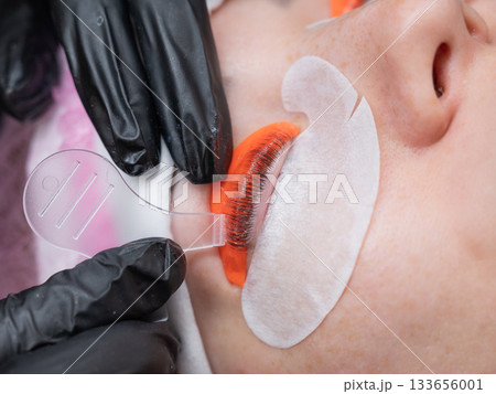 Caucasian woman undergoing eyelash lamination procedure.  133656001