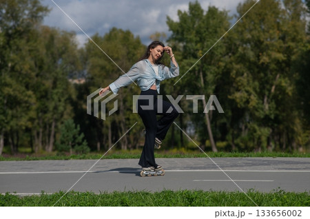 Caucasian woman roller skating in park.  133656002