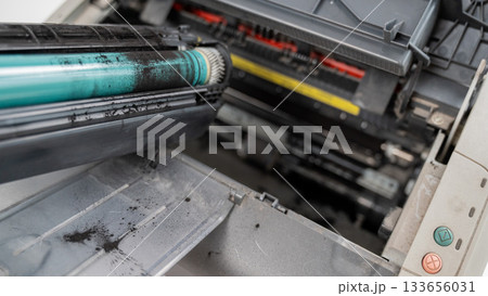 Broken laser printer cartridge on white background.  133656031