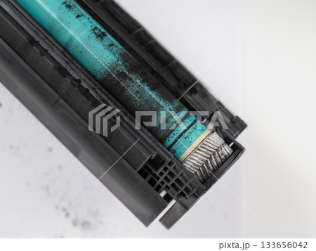 Broken laser printer cartridge on white background. Broken laser printer cartridge on white background. 133656042