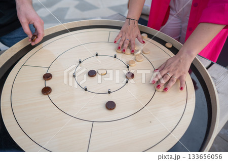 Strategic Game Pieces on a Wooden Board crokinole.  133656056