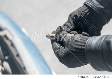 Caucasian man changing spark plugs in car.  133656108