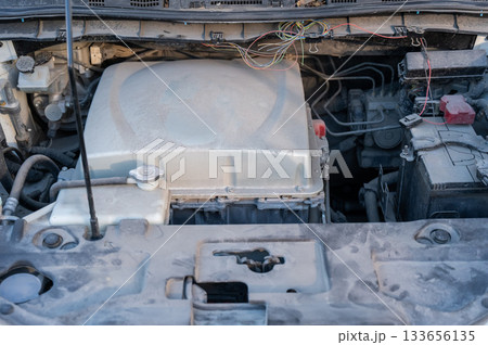 Electric motor under the hood of a car.  133656135