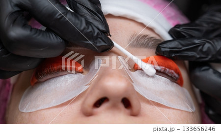 Caucasian woman undergoing eyelash lamination procedure. Caucasian woman undergoing eyelash lamination procedure. 133656246
