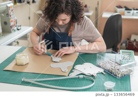 Woman tanner at work in the workshop.  133656469