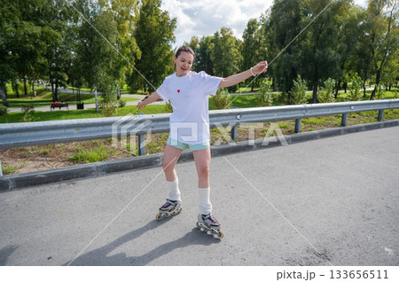 Caucasian woman in shorts roller skating.  133656511