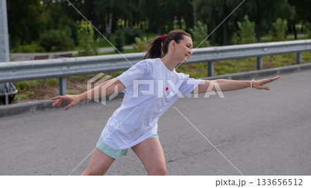 Caucasian woman rollerblading fast on road.  133656512