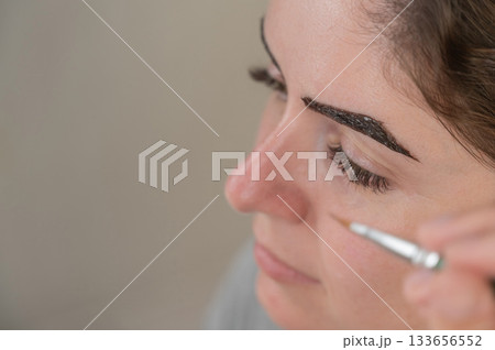 Caucasian woman getting eyebrow tinting procedure.  133656552