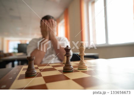 Middle aged Caucasian man playing chess. Middle aged Caucasian man playing chess. 133656673