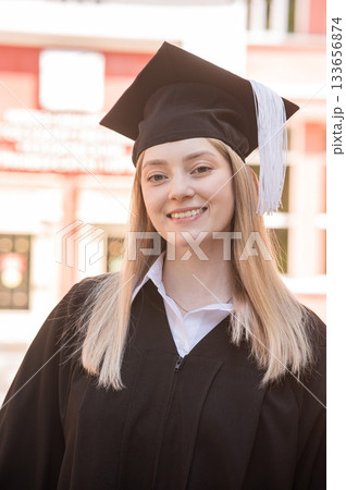 Portrait of a young Caucasian woman in a graduation gown. Portrait of a young Caucasian woman in a graduation gown. 133656874