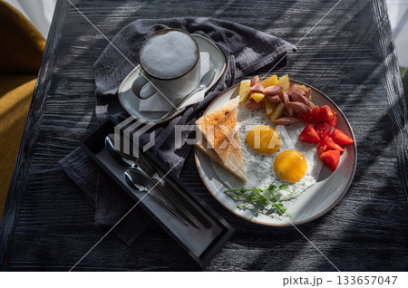 Fried eggs served in a cafe.  133657047