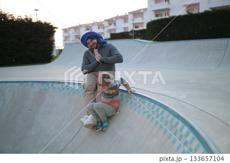 Father and son enjoying a day at the skatepark Father and son enjoying a day at the skatepark 133657104