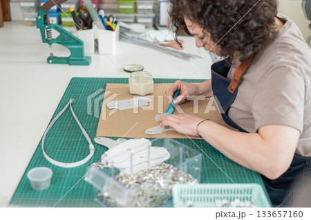 Woman tanner at work in the workshop.  133657160
