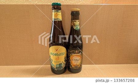 Banana beer and fruit beer bottles on the table Banana beer and fruit beer bottles on the table 133657208