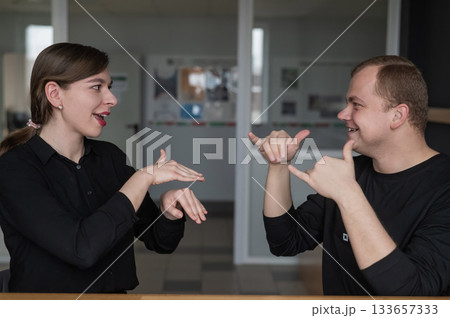 A man and a woman are talking in Russian sign language. A man and a woman are talking in Russian sign language. 133657333