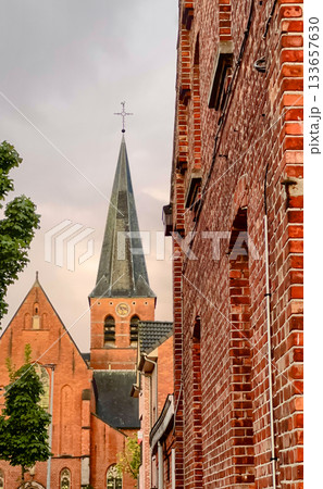 Quiet walk past old masonry and leafy surroundings at dusk 133657630