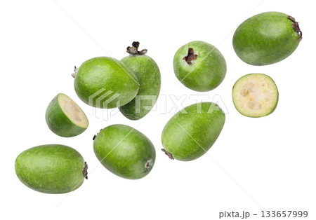 Feijoa fruits and halves flying close-up on a white. Isolated 133657999