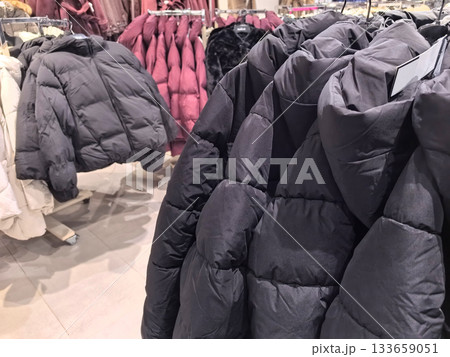 Warm jackets displayed in a cozy clothing store during winter shopping season 133659051