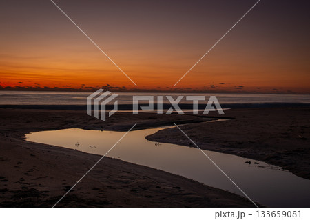 河原子海岸の夜明け前の空と砂浜を流れる小川の静景 133659081