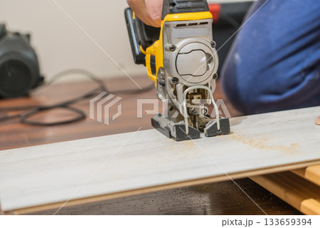 Person cutting floor panels Person cutting floor panels 133659394