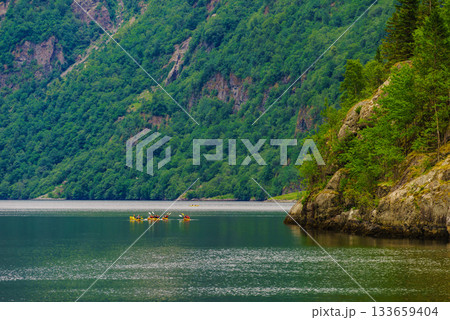 fjord in Norway and people kayaking fjord in Norway and people kayaking 133659404