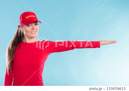 Happy lifeguard woman in cap pointing direction. Happy lifeguard woman in cap pointing direction. 133659615