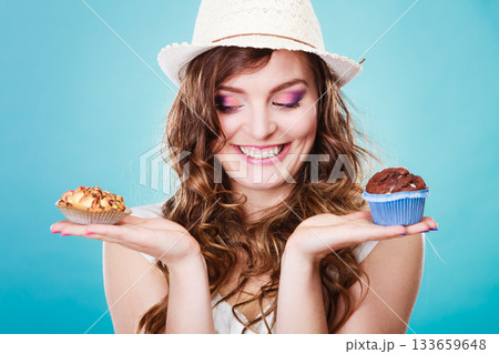 Smiling summer woman holds cakes in hand 133659648