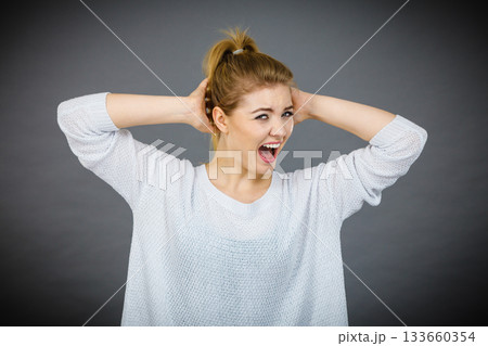 Unhappy woman screaming and yelling in pain 133660354