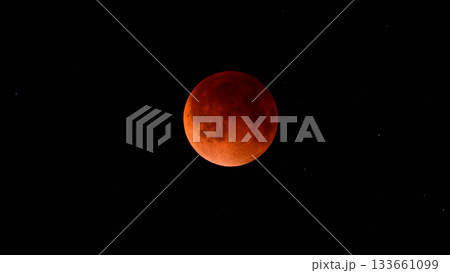Blood moon during a lunar eclipse in the night sky. The moon appears red as it is shadowed by the Earth 133661099