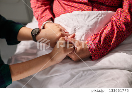 Holding hands in a caring moment between two people during a quiet afternoon 133661776