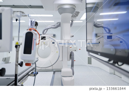Advanced medical imaging room with high-tech CT scanner and modern equipment in a clean environment Advanced medical imaging room with high-tech CT scanner and modern equipment in a clean environment 133661844